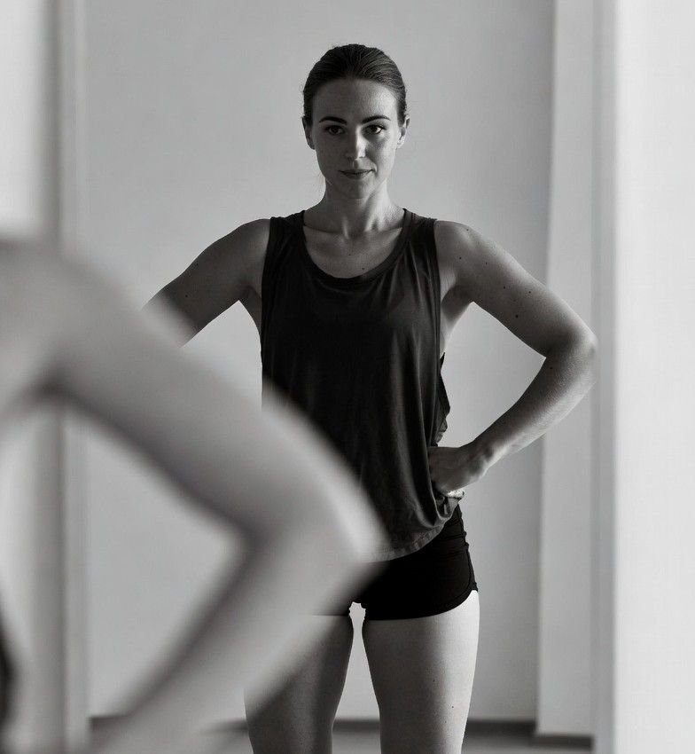 confident person standing in front of a mirror after a workout, natural lighting, realistic style
